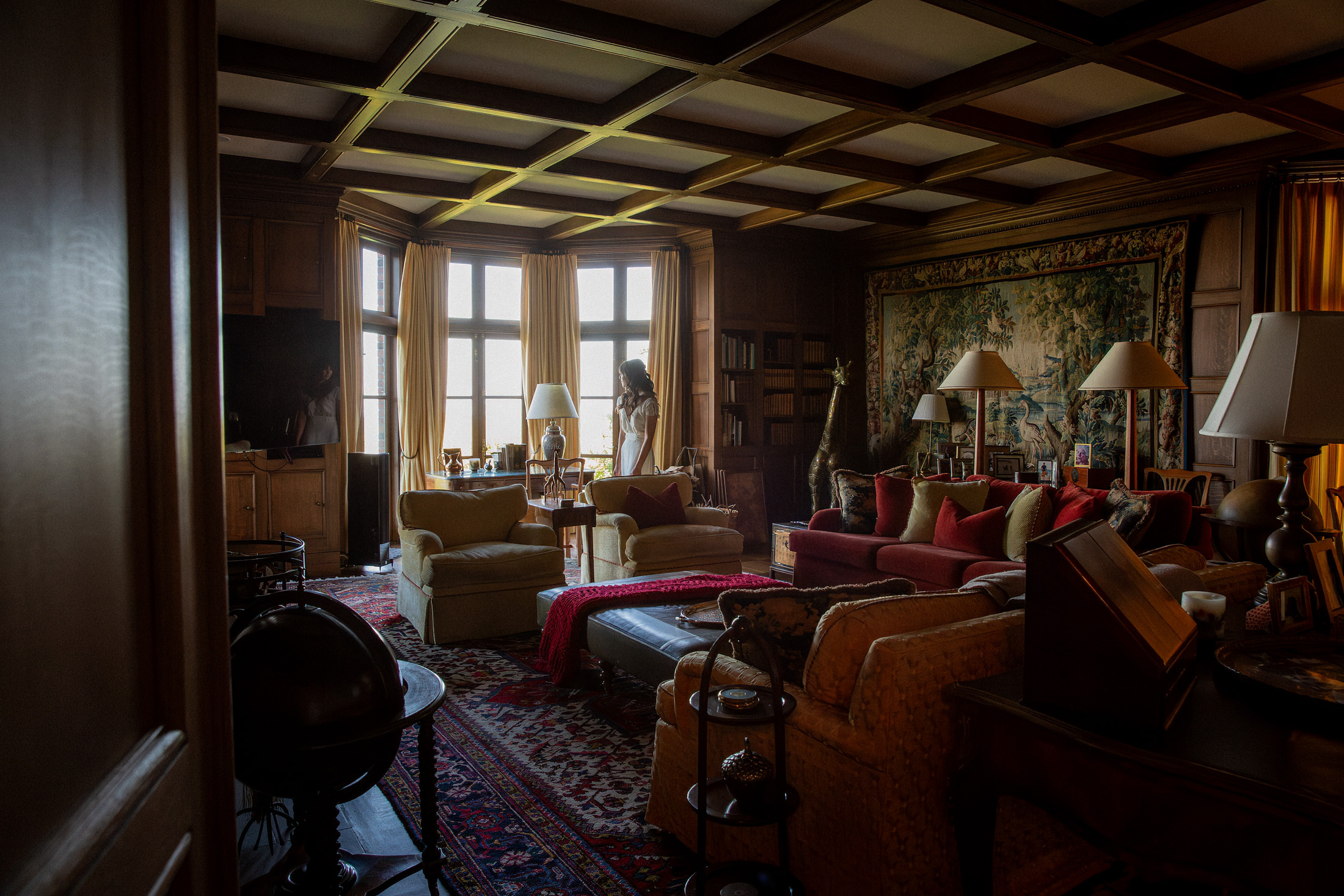Dark cinematic interior room of private estate with rich furnishings, luxury editorial photography