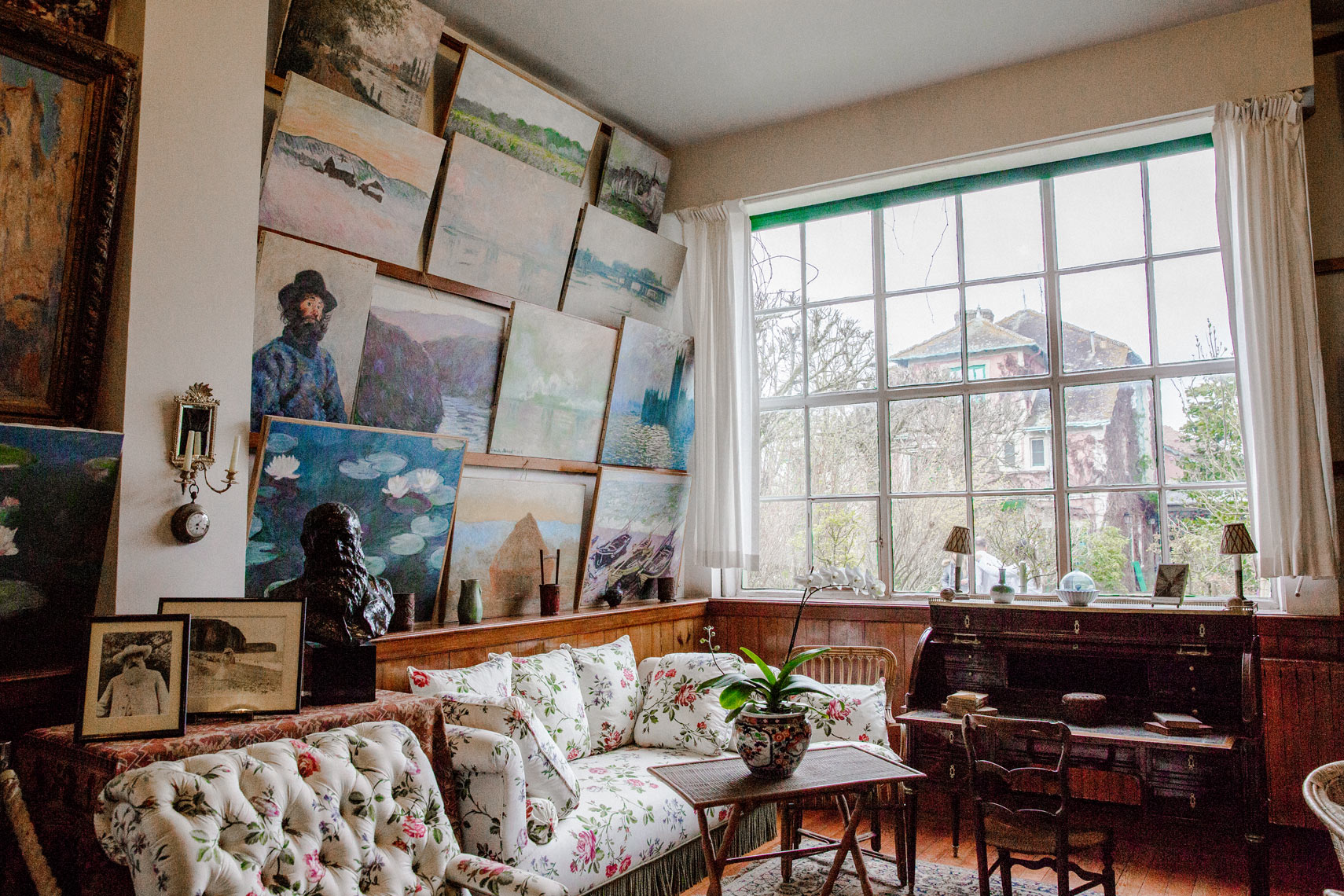 eclectic Giverny France interior room paintings gallery wall tufted sofa natural window light travel editorial photography