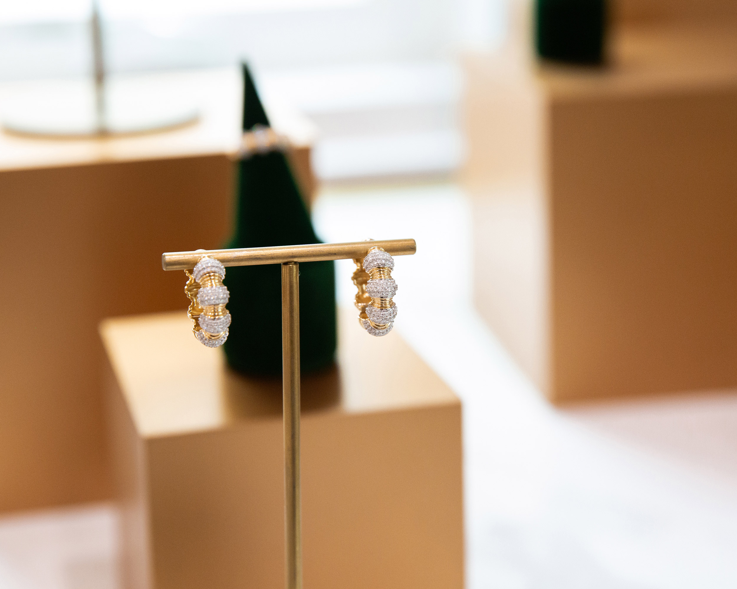 Miraco diamond drop earrings gold velvet stand luxury jewelry brand photography