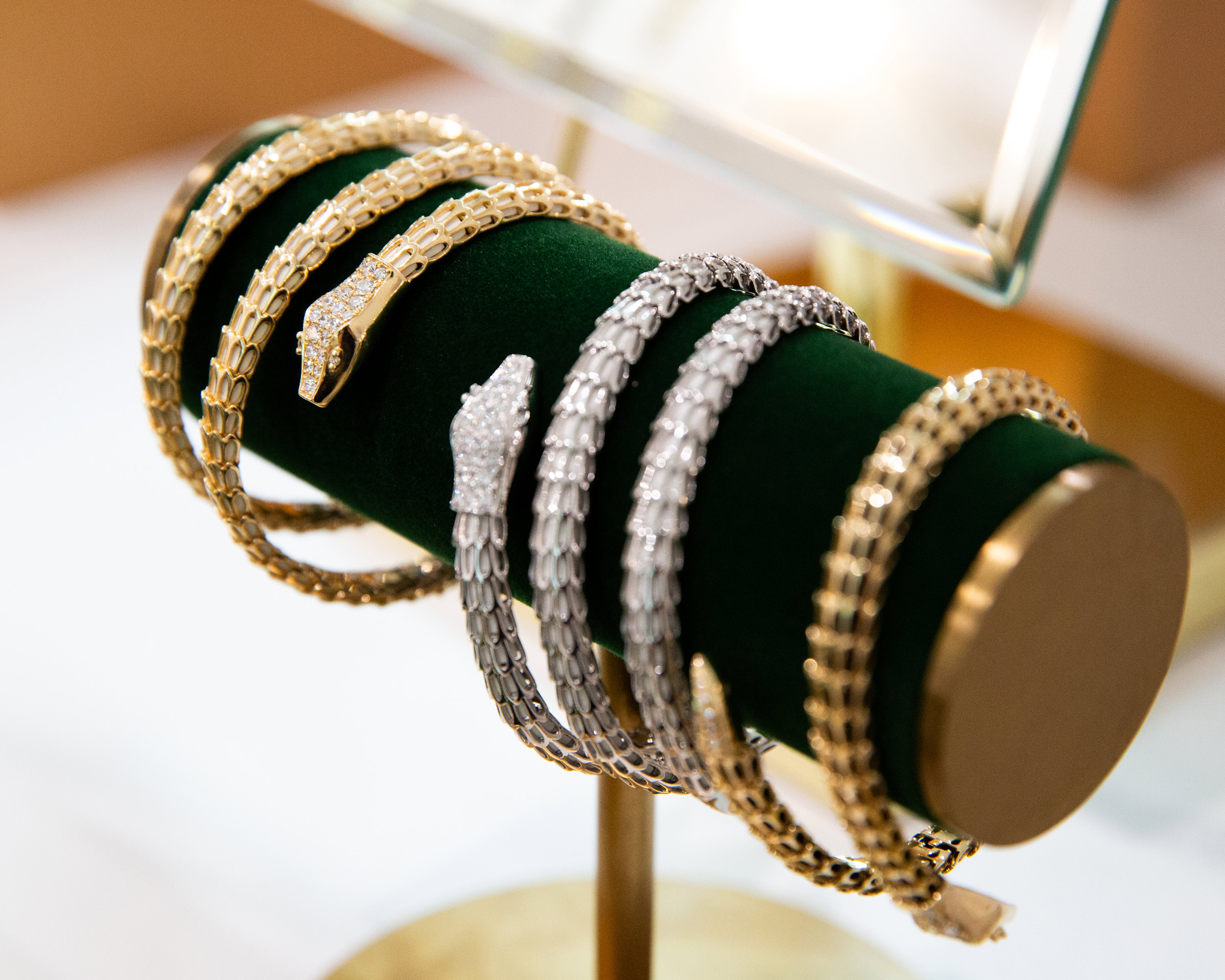Miraco gold silver bracelets velvet roll display luxury jewelry brand photography