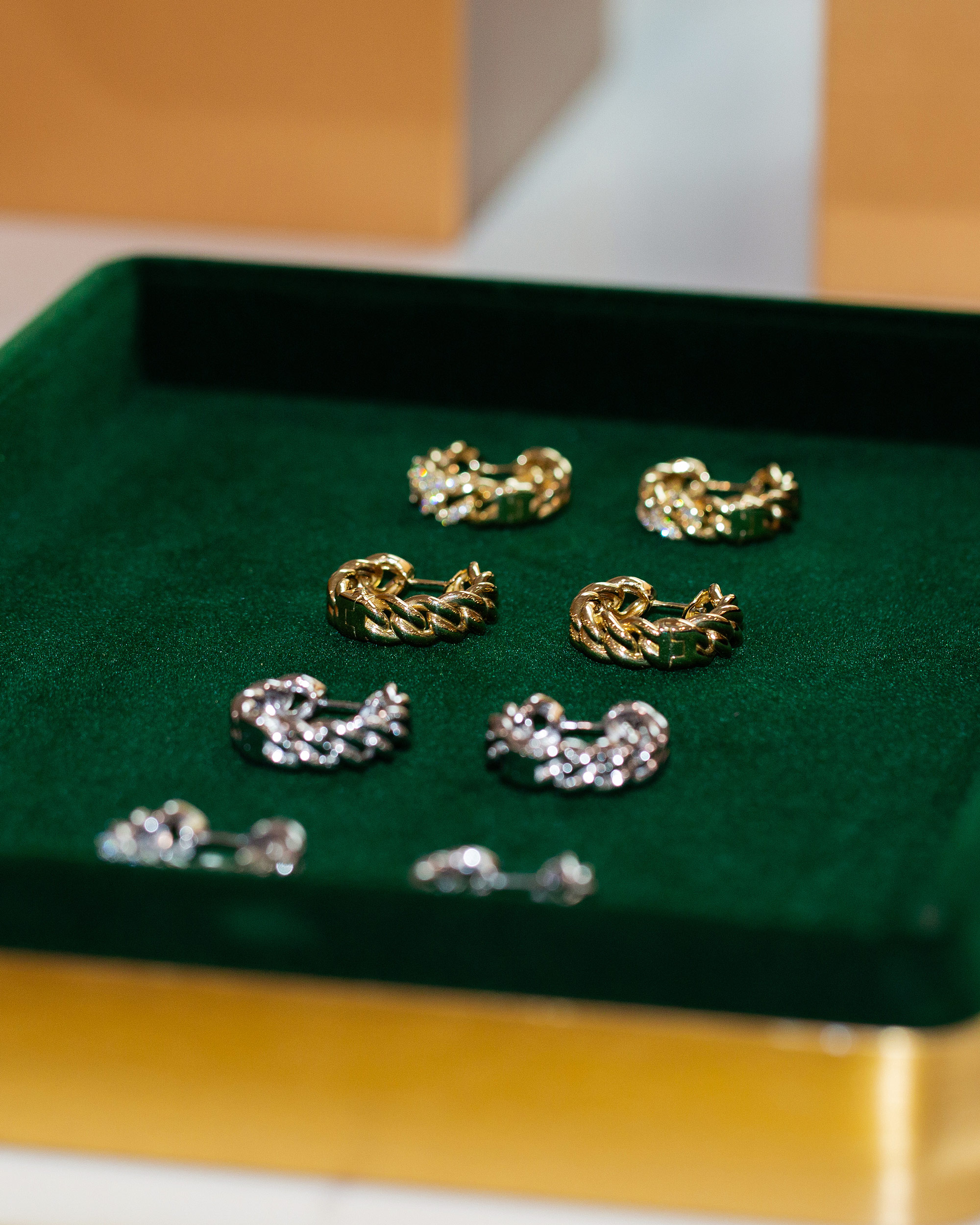 Miraco gold silver earrings green velvet tray detail luxury jewelry brand photography