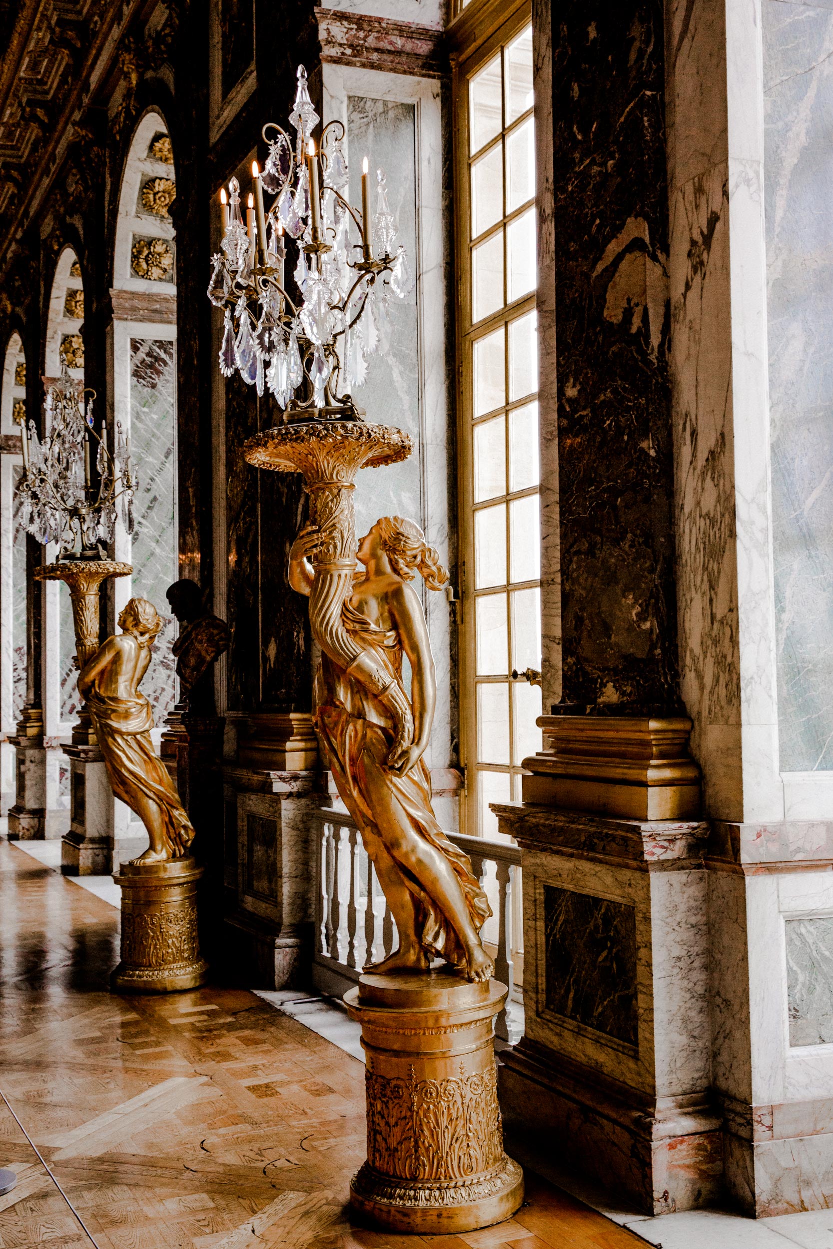 gilded ornate interior gold columns chandelier Versailles Paris travel editorial photography