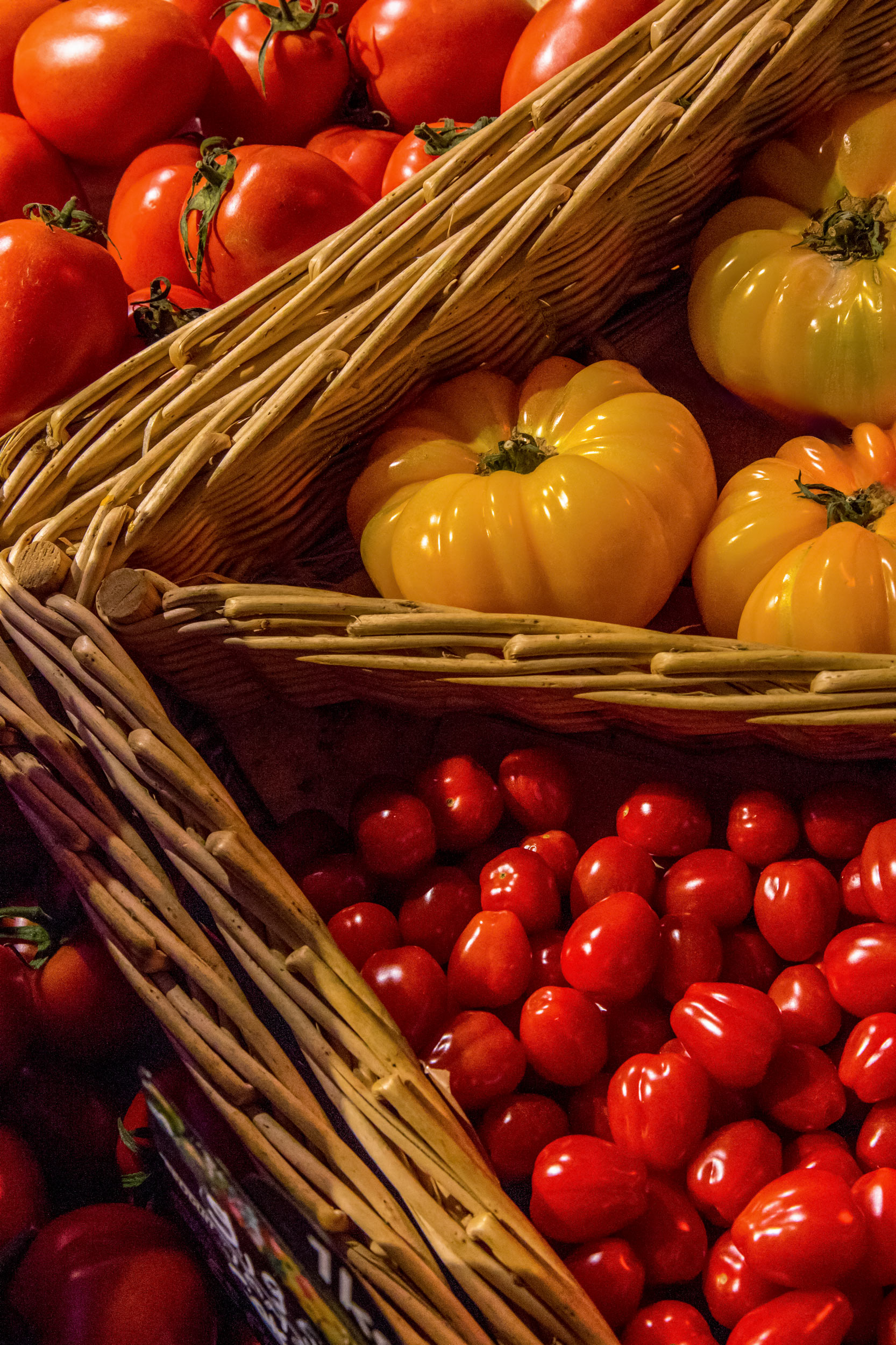overhead view colorful tomatoes vegetables baskets Paris market travel editorial photography