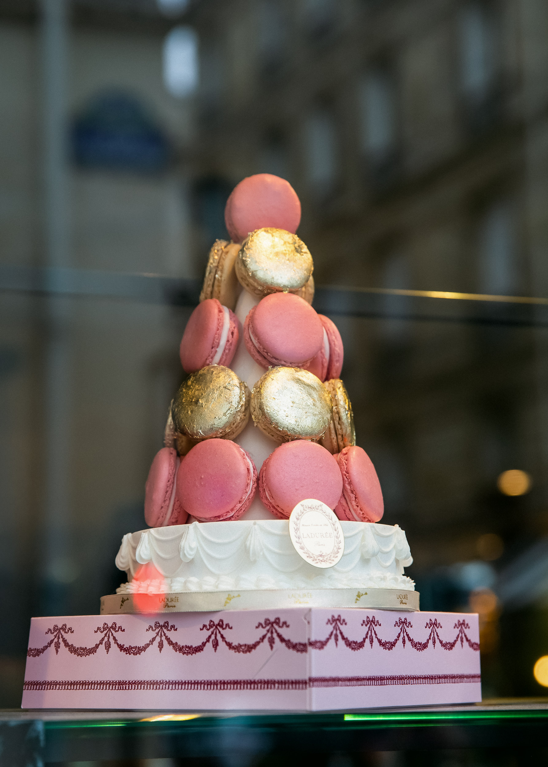 pink macaron tower patisserie window display Paris travel editorial photography