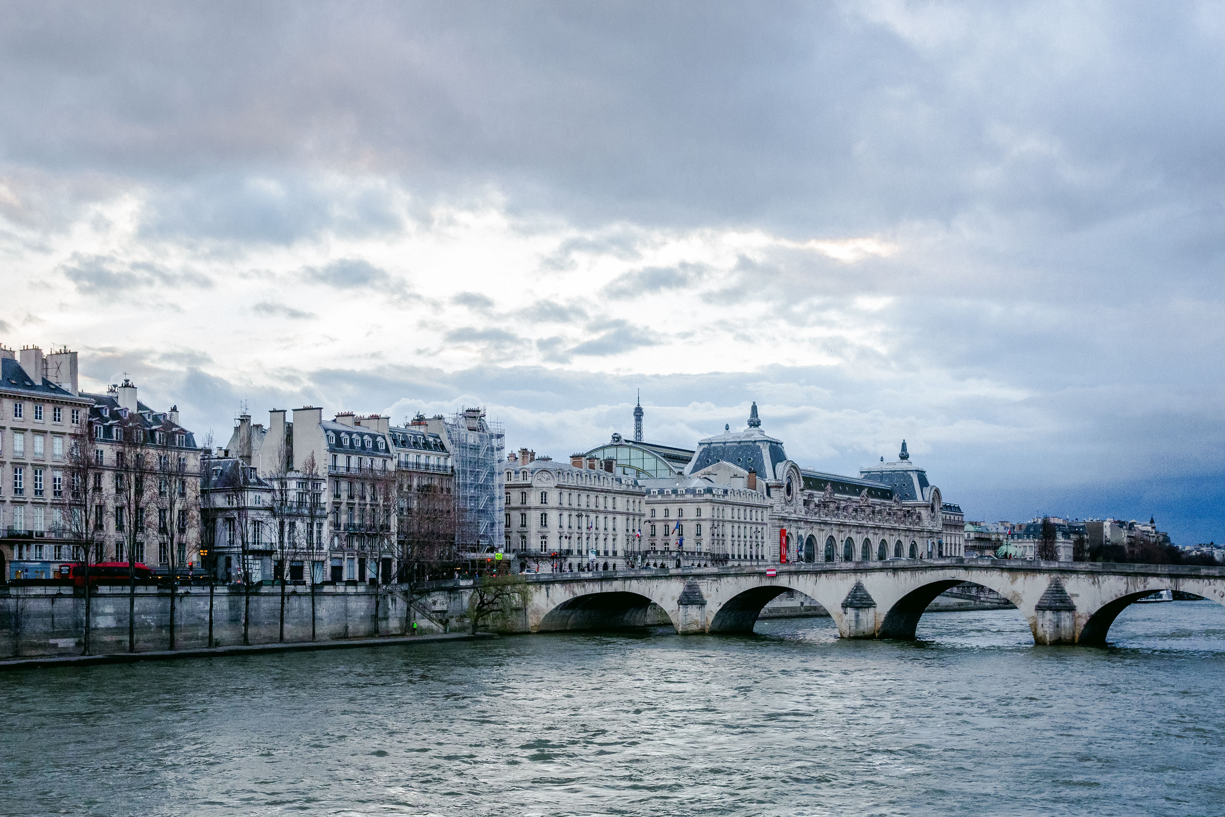 Seine river stone bridge Paris overcast sky travel editorial photography