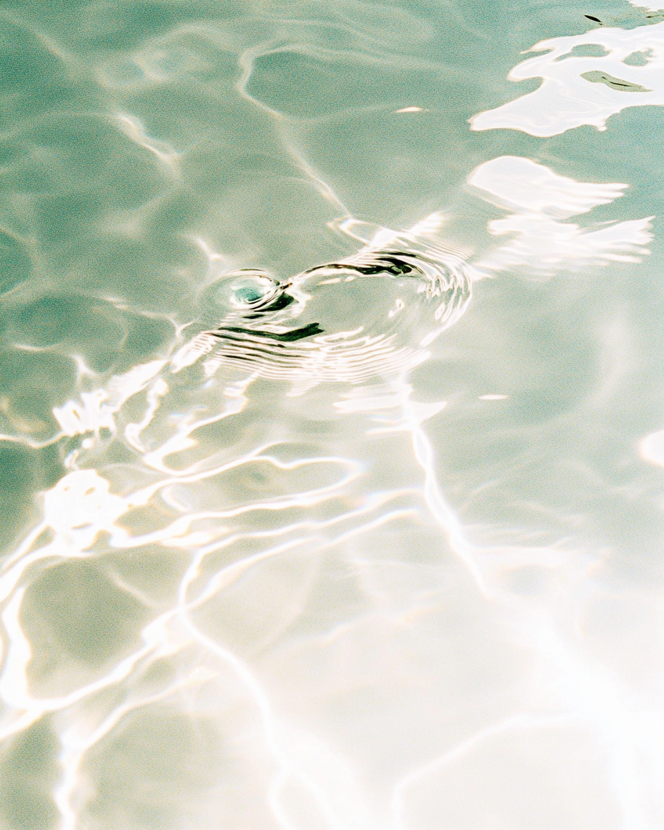 AI-generated mineral water surface, cyan and jade tones, film grain, analog photography aesthetic, Latent Beauty series