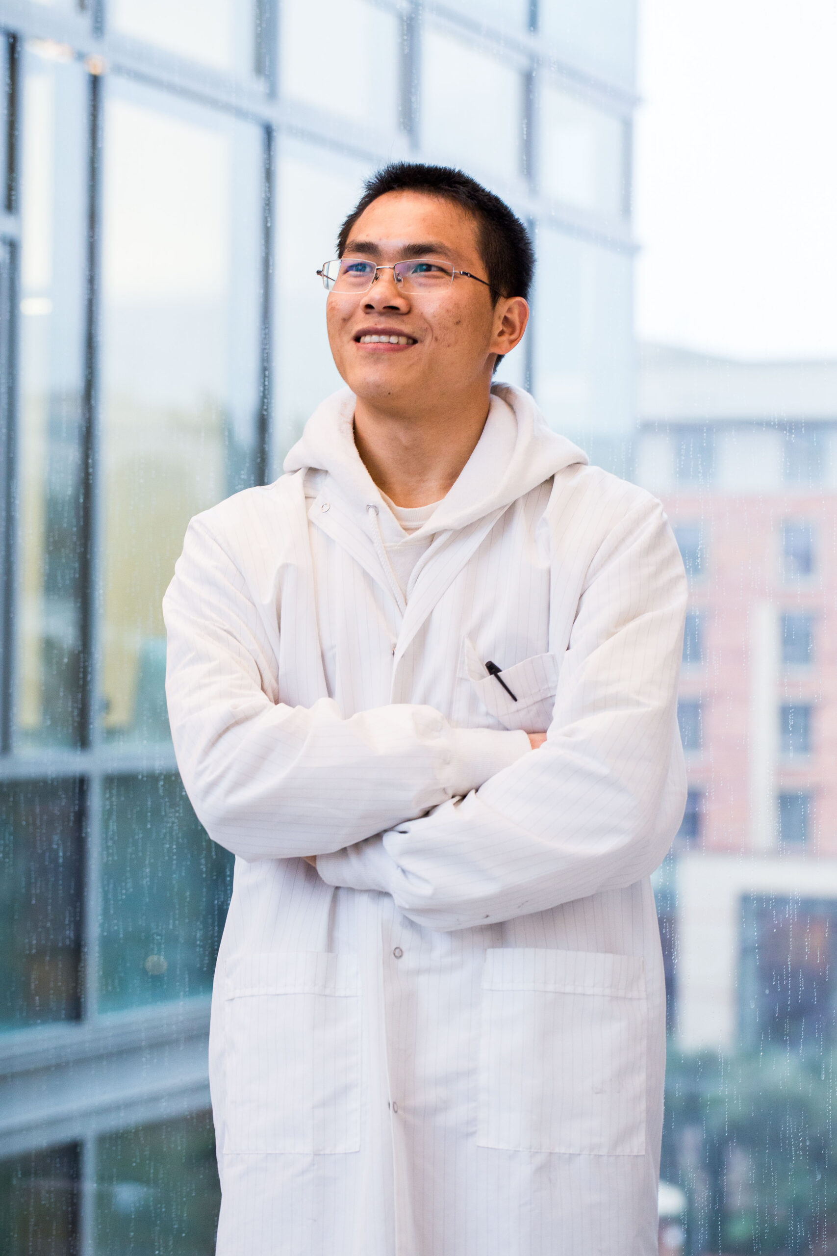 UCLA scientist in lab coat smiling on campus, brand portrait photography