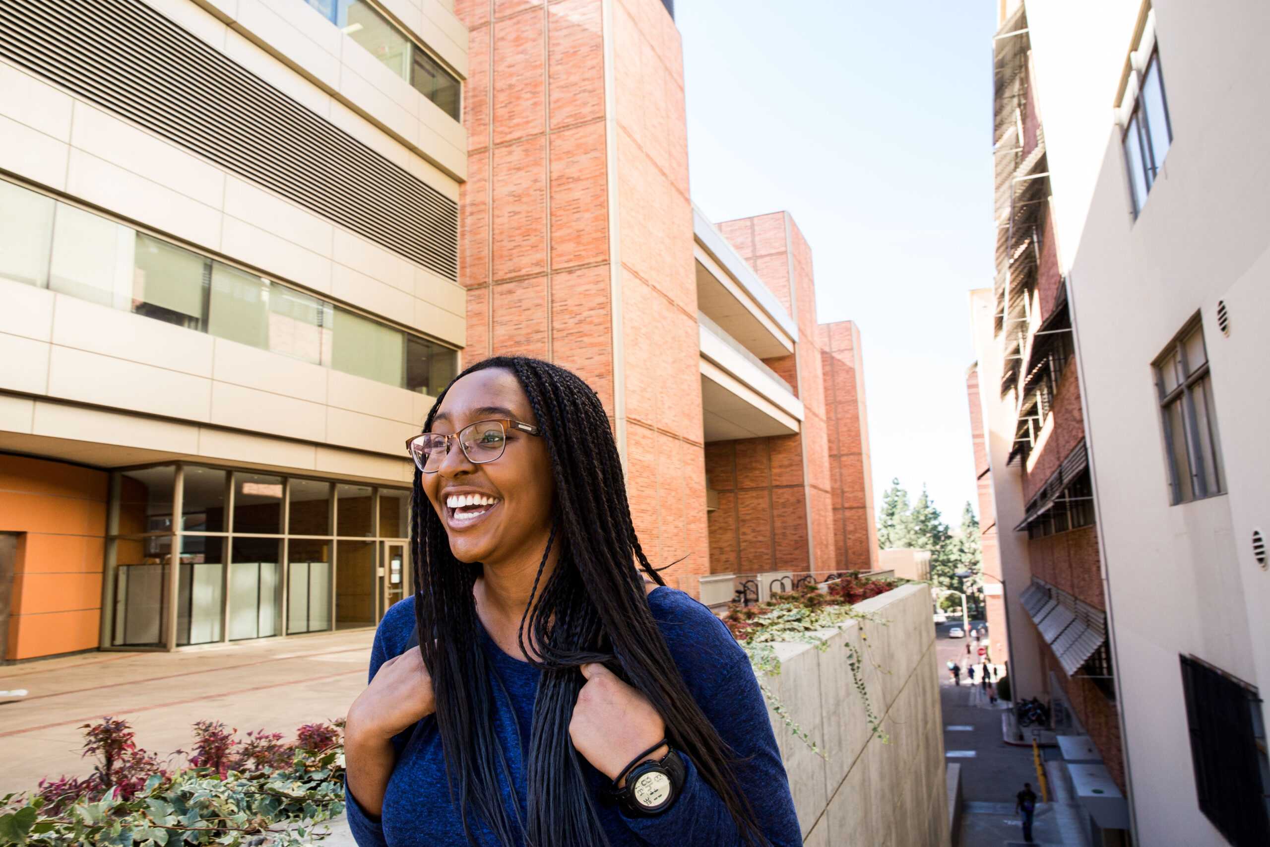 UCLA student smiling beside campus architecture, brand lifestyle portrait photography