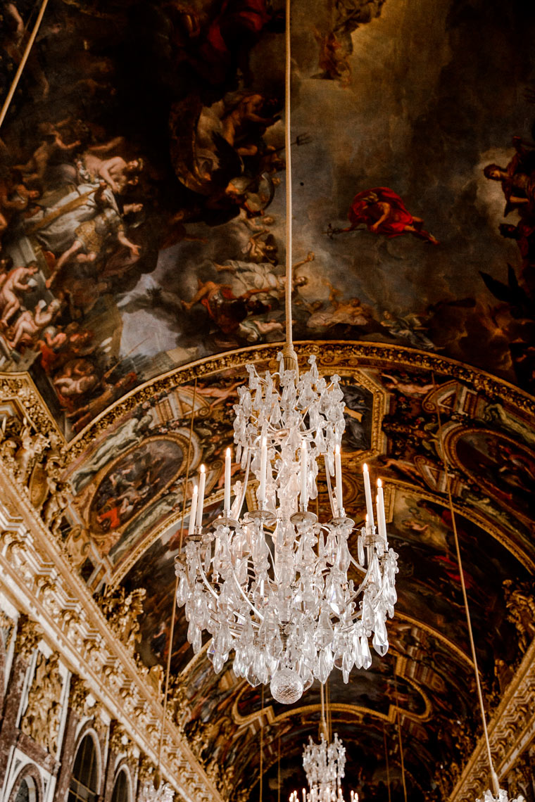 Crystal chandelier against gilded painted ceiling, Versailles luxury architectural photography