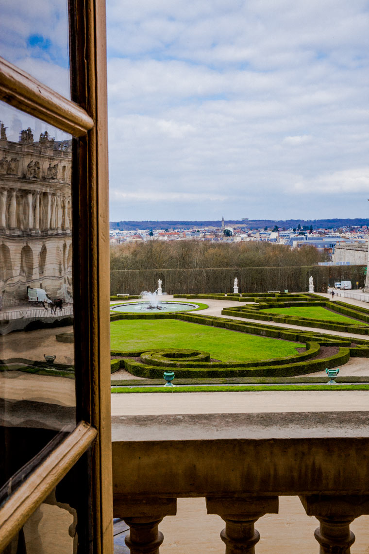 view from Versailles chateau window over formal gardens France travel editorial photography