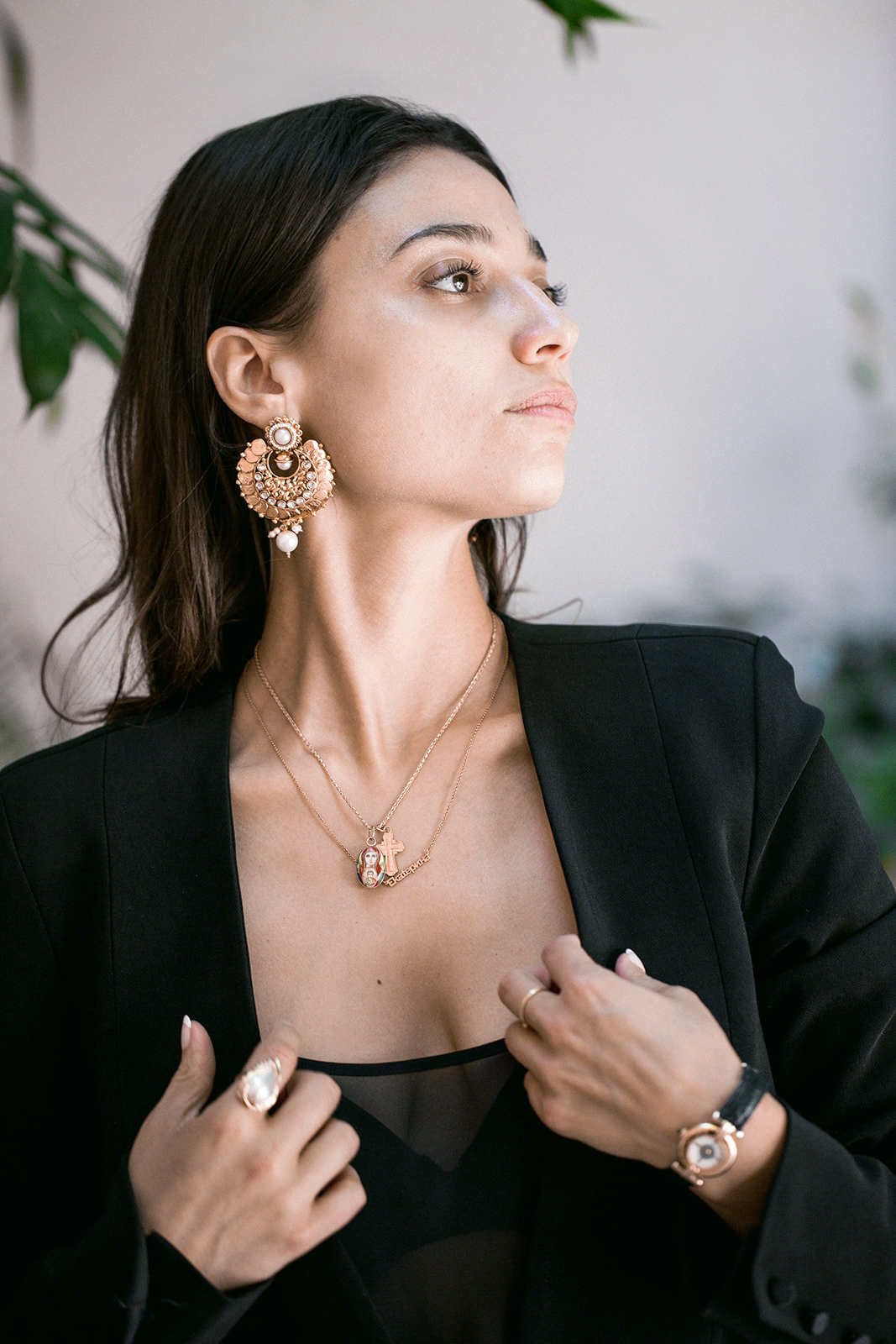 woman black blazer gold chandelier earrings looking up intimate close-up brand portrait photography