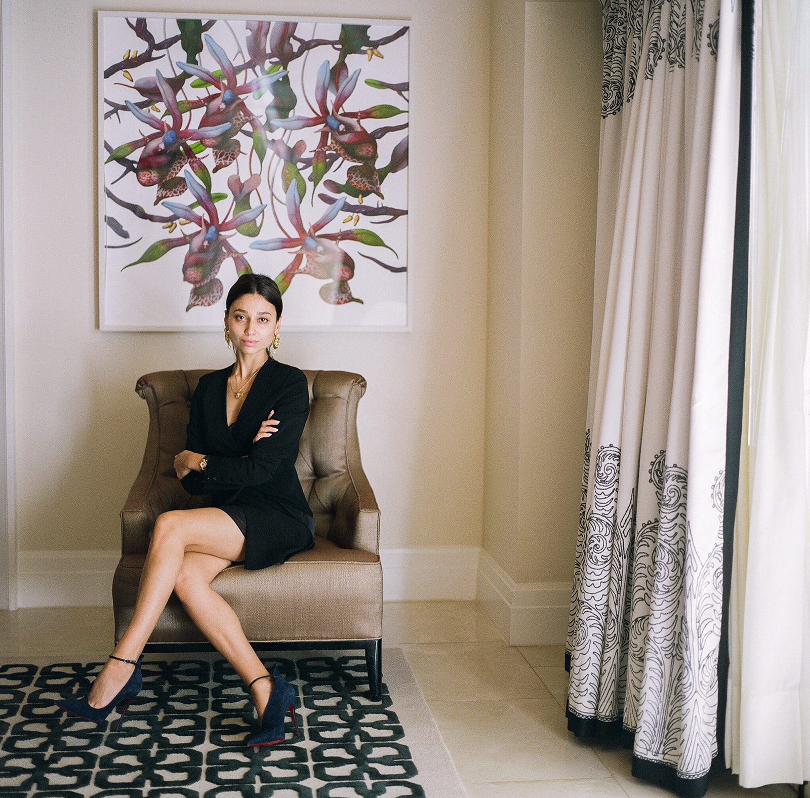 woman black blazer seated leather chair botanical artwork confident brand portrait photography