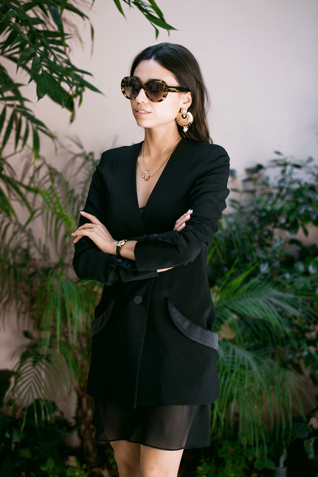 woman black blazer oversized sunglasses arms crossed tropical foliage brand portrait photography
