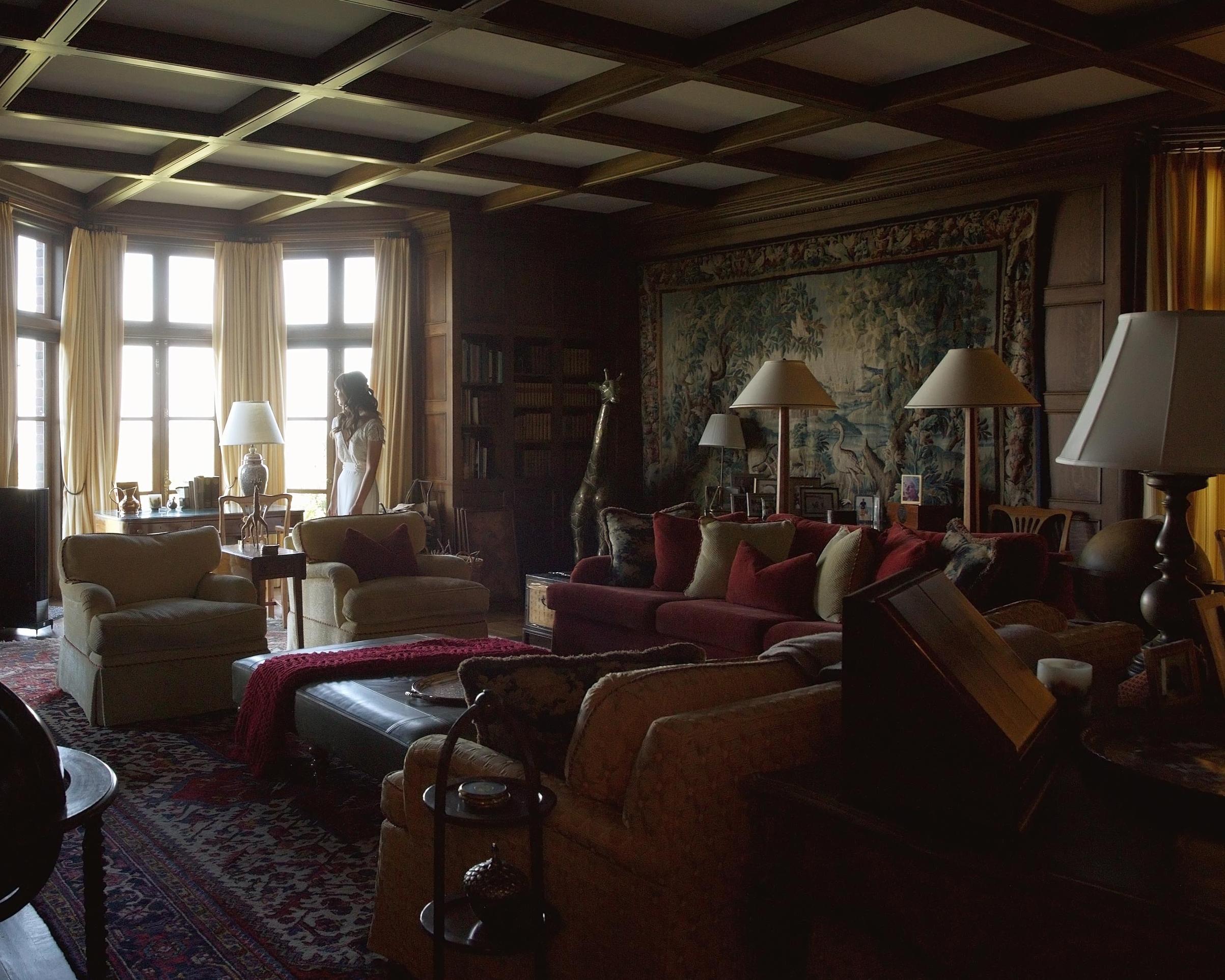 Dark cinematic interior room of private estate with rich furnishings, luxury editorial photography